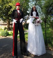 Bride and Groom stilt walkers